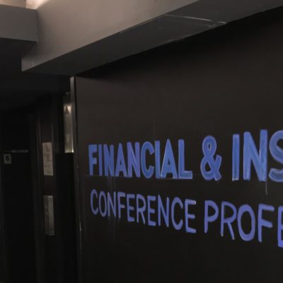 chalkboard wall with "Financial and Insurance Conference Professionals" written in blue