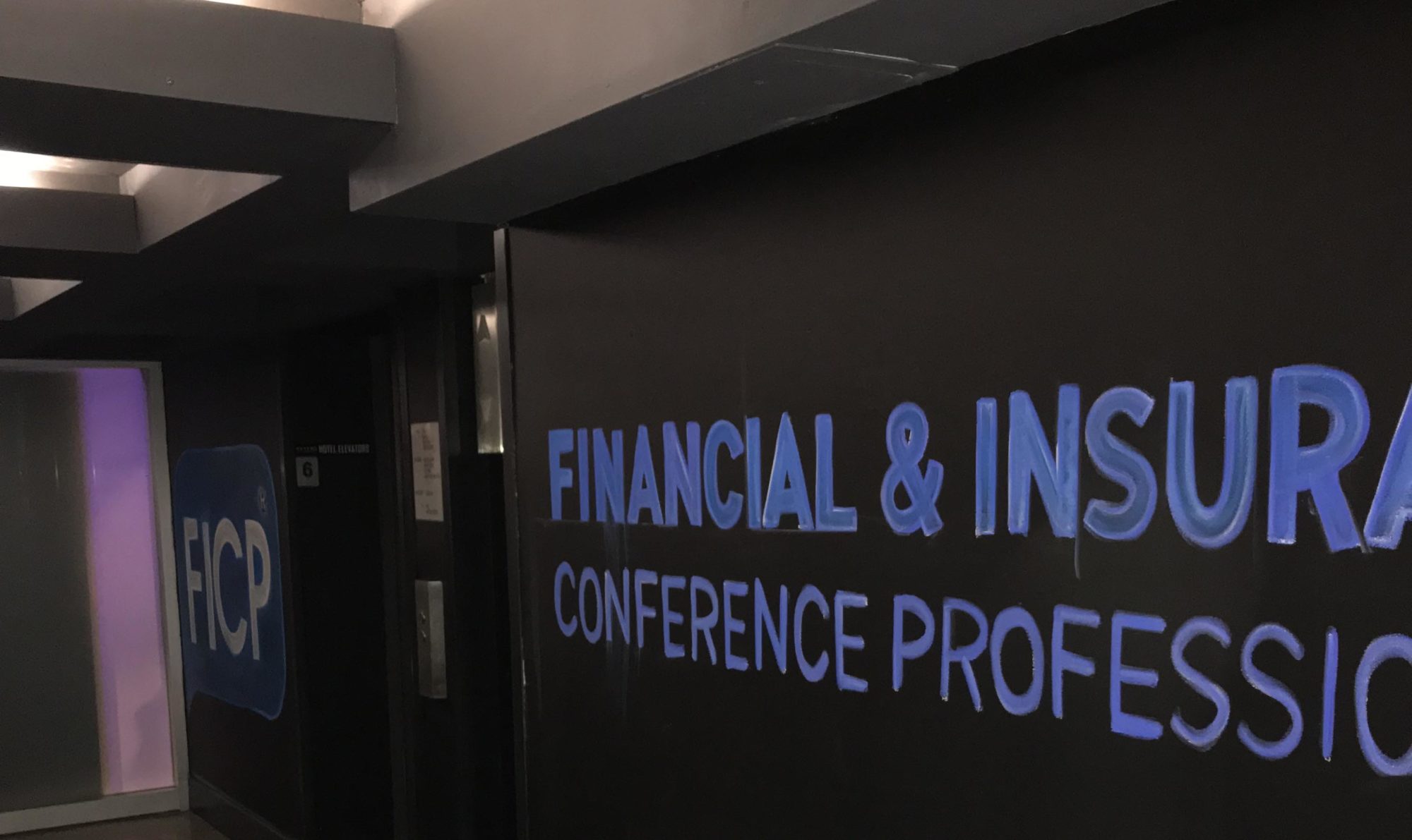 chalkboard wall with "Financial and Insurance Conference Professionals" written in blue
