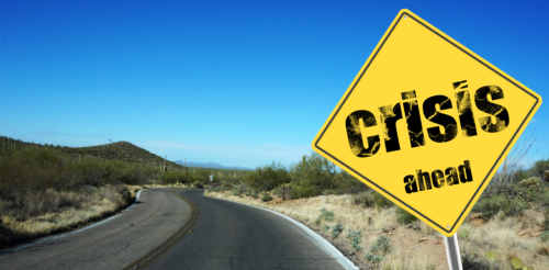 crisis ahead sign by road